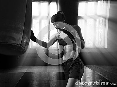 Professional athlete trains a blow to the bag in the gym Stock Photo