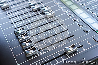 Professional audio mixing console buttons, faders and sliders. Stock Photo