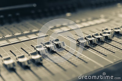Professional audio mixing console with faders and adjusting knobs, TV equipment Stock Photo