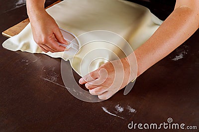 Professional baker cover cake with fondant smoother Stock Photo