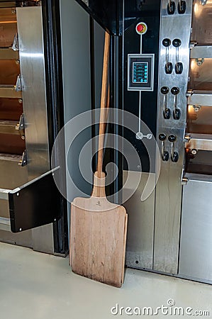 Professional baker`s oven and wooden shovel Stock Photo