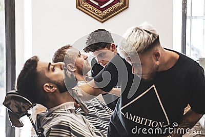 Professional barber who cuts beard and hair Editorial Stock Photo
