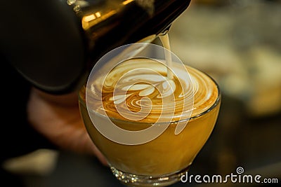 Barista making coffee latte art in crystal glass.sensitive focus Stock Photo