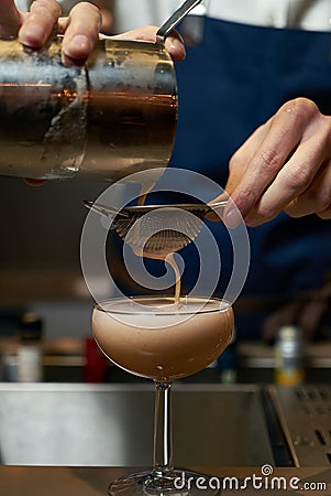 Professional bartender making a cocktail at the bar counter Stock Photo