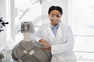 Professional black female stomatologist doctor posing at workplace in modern clinic Stock Photo