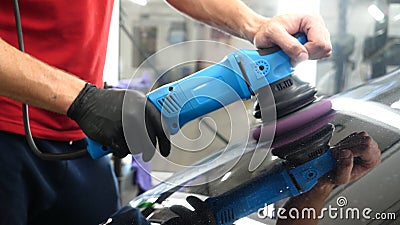 A professional bodywork and headlamp polishing worker will transport the car after painting or preparing for sale. Concept of: Fre Stock Photo