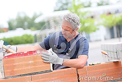 Professional brick layer making wall construction Stock Photo