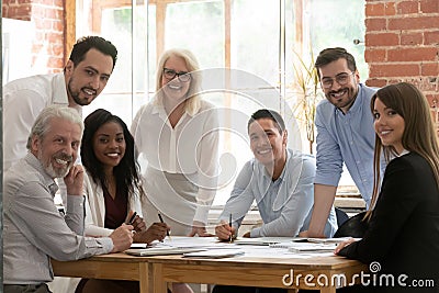 Professional business team young and old people posing at table Stock Photo
