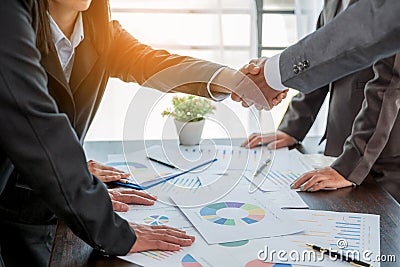 Professional businessman and businesswoman partners shaking hands together with business success deal and agreement. Hands Stock Photo