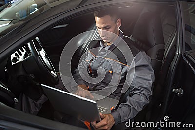 Professional car mechanic working in auto repair service Stock Photo