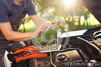 Professional car mechanic working in auto repair service, photog Stock Photo