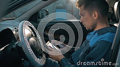 Professional car mechanic working in modern auto repair service and checking engine Stock Photo