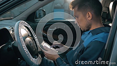 Professional car mechanic working in modern auto repair service and checking engine Stock Photo