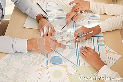 Professional cartographers working with cadastral map at table, closeup Stock Photo
