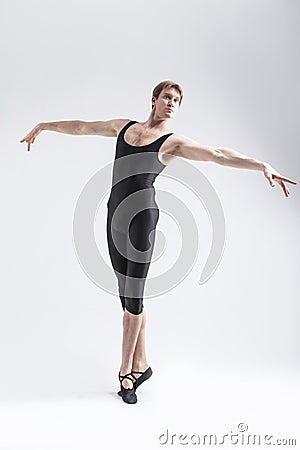 Professional Caucasian Male Ballet Dancer Flexible Athletic Man Posing in Black Tights in Ballanced Dance Pose Stock Photo