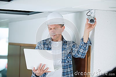 Professional cctv technician checking instruction Stock Photo