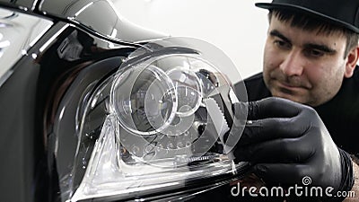 Professional ceramics handler apply different layers to the car using an applicator sponge, fiber immediately checking the effec Stock Photo