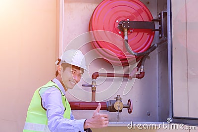 A Professional checking aFire extinguisher Stock Photo