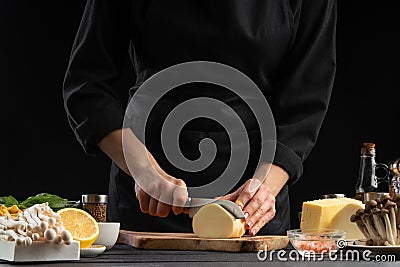 A professional chef prepares a fresh and healthy Italian salad slicing mazzarella cheese, Organic and wholesome food. Healthy Stock Photo