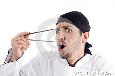 Professional chef surprised with chopstick Stock Photo