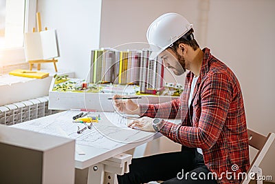 Professional civil engineer working with documents, drawings in office Stock Photo