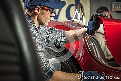 Professional Classic Cars Mechanic Taking Closer Look Stock Photo