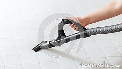 Professional cleaning mattress by vacuum cleaner from dust bacteria dirty. Female hand use vacuum cleaner machine for cleaning Stock Photo