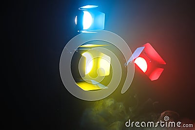Professional color lighting equipment with fume on dark background Stock Photo