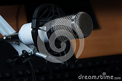 Professional condenser studio microphone over the keyboard Stock Photo