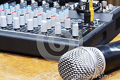 Professional condenser studio microphone over the musician blurred background and audio mixer, Musical instrument Concept. Stock Photo