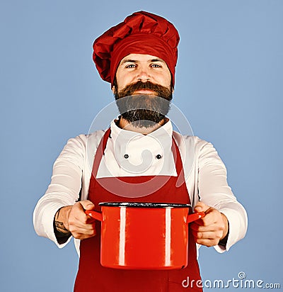 Professional cookery concept. Cook with happy face in burgundy uniform Stock Photo