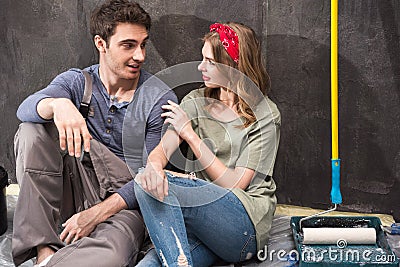 Professional couple sitting together on floor and discussing renovation home Stock Photo