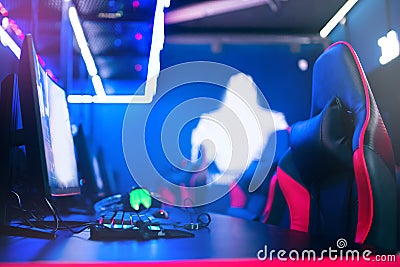 Professional cyber gamer studio room with personal computer armchair, keyboard for stream in neon color blur background Stock Photo