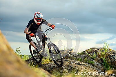 Professional Cyclist Riding the Bike on the Rocky Trail. Extreme Sport. Stock Photo