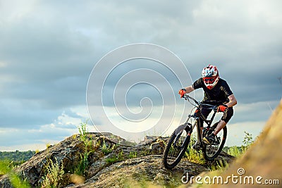 Professional Cyclist Riding the Bike on the Rocky Trail. Extreme Sport. Stock Photo