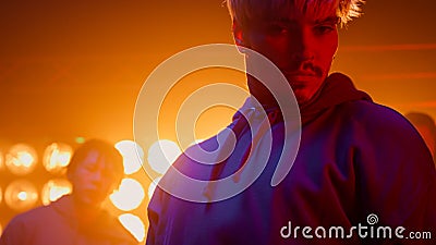 Dancer guy making rhythmic movements with friends in nightclub. Group performing Stock Photo