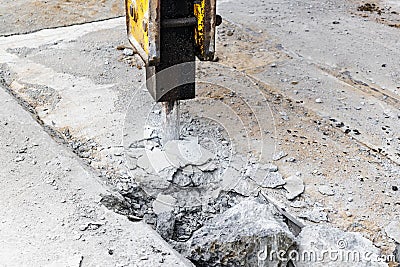 Professional demolition of reinforced concrete structures with an industrial hydraulic hammer with an excavator. Dismantling the Stock Photo