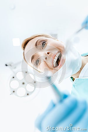 Professional dentist working in clinic and looking at camera Stock Photo