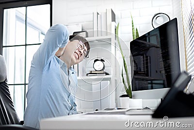 Professional development programmers are suffer from backaches or twists or stretching after completing their programming work Stock Photo