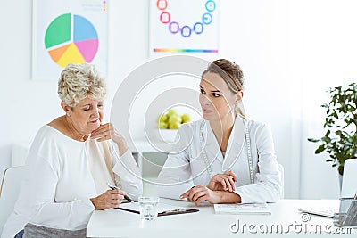 Dietician talking about healthy diet during nutrition consultation with a patient Stock Photo