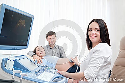 Professional doctor diagnosing pregnant woman. Stock Photo