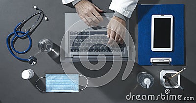 Professional doctor working at office desk Stock Photo