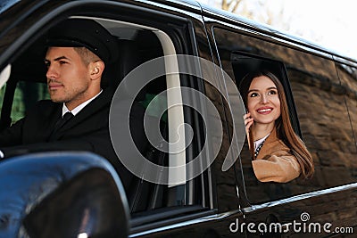 Professional driver and businesswoman in car. Chauffeur service Stock Photo