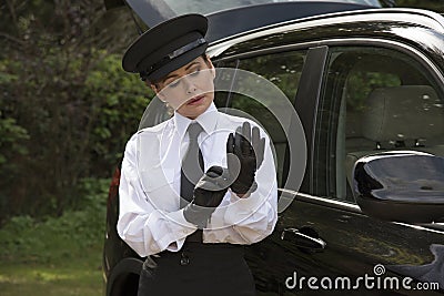 Professional driver putting on her driving gloves Stock Photo