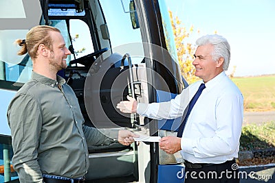 Professional driver taking ticket from passenger Stock Photo