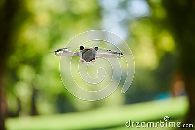 Professional drone filming the park on a sunny day Stock Photo