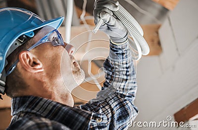 Professional Electrician Closer Look Stock Photo