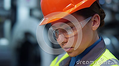 Closeup engineer looking camera wearing safety uniform on modern facility. Stock Photo