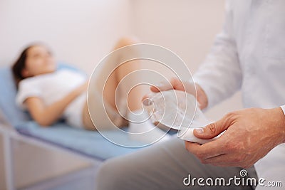 Professional experienced doctor preparing to make a bandage Stock Photo