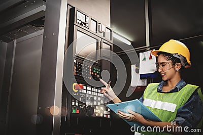 Automatic control of metal lathes at the control works by talented Asian female engineers. Stock Photo